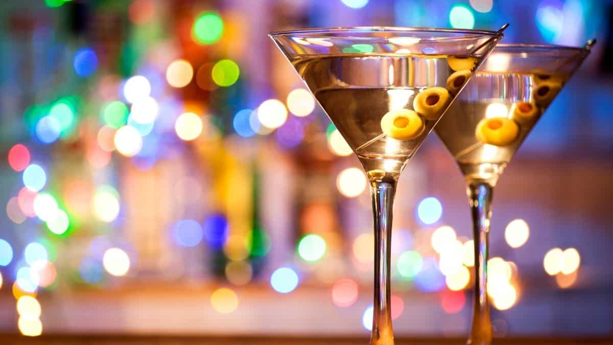 two martini glasses with four olives in each, something someone may drink on new years eve.