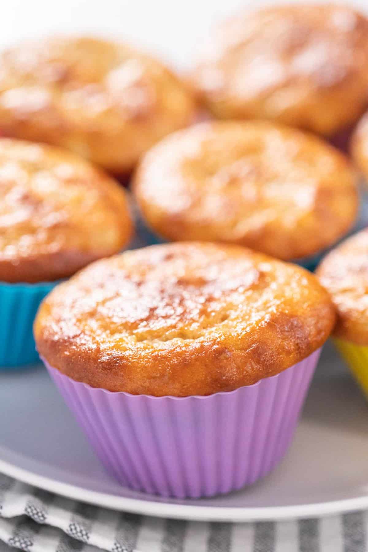 Banana protein muffin in a purple liner.