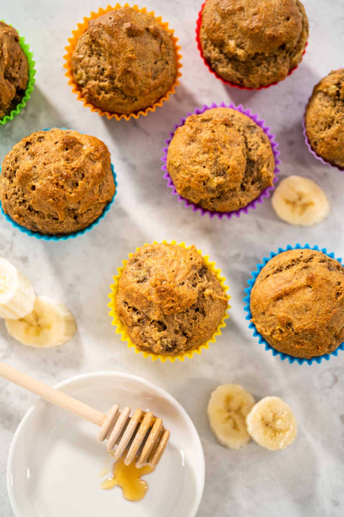 Overhead shot of Almond Flour Banana Muffins in colorful muffin liners.