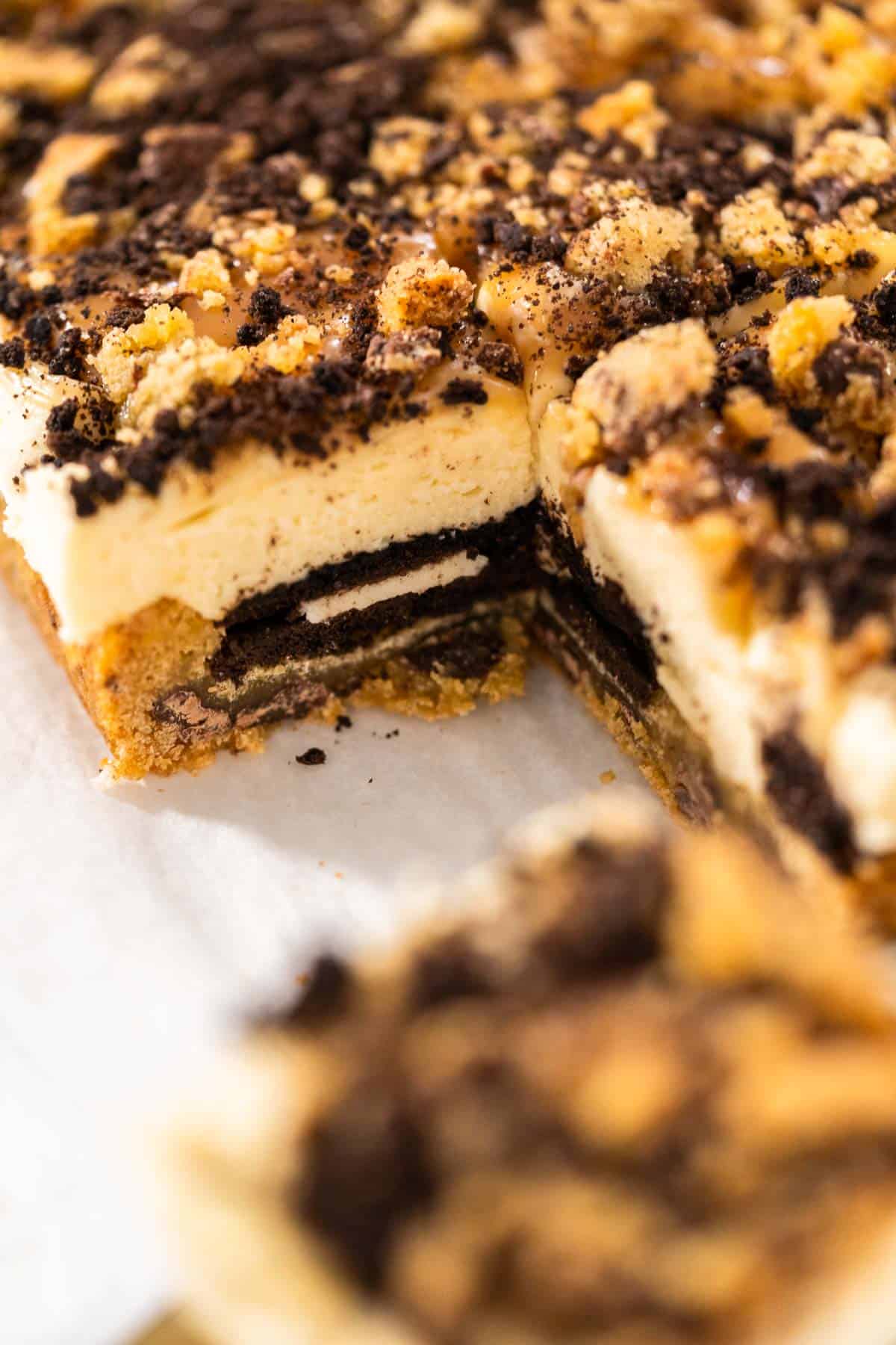 A side view of slutty cheesecake bars to show the layers.