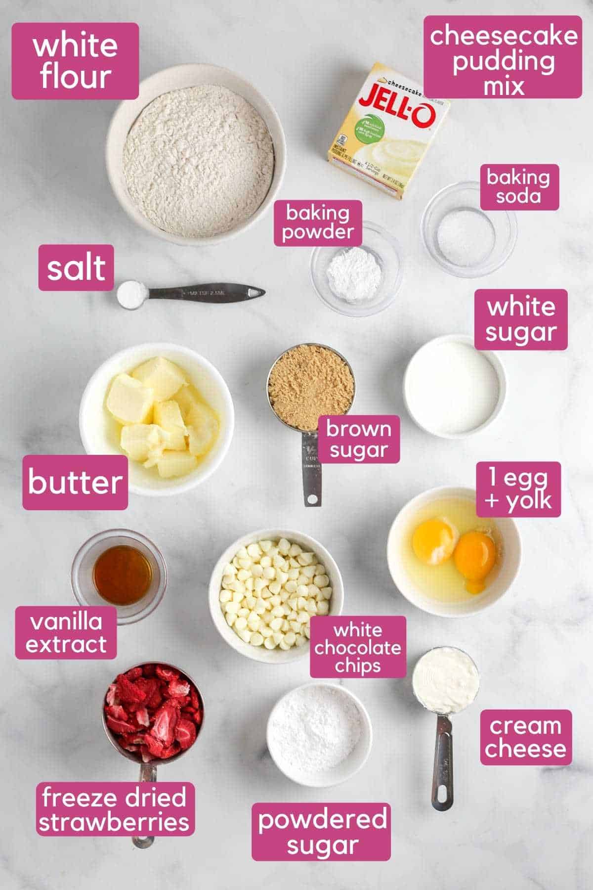 The ingredients needed to make strawberry cheesecake cookies, including strawberries and cream cheese.