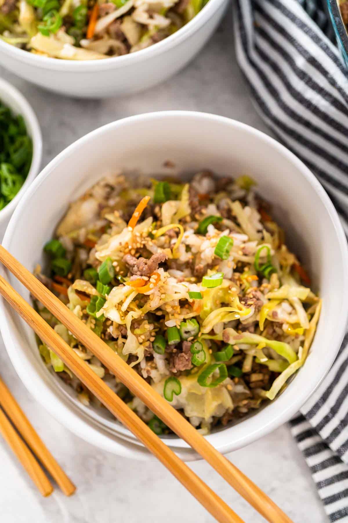 A bowl of Inside Out Egg Roll, served with chopsticks.