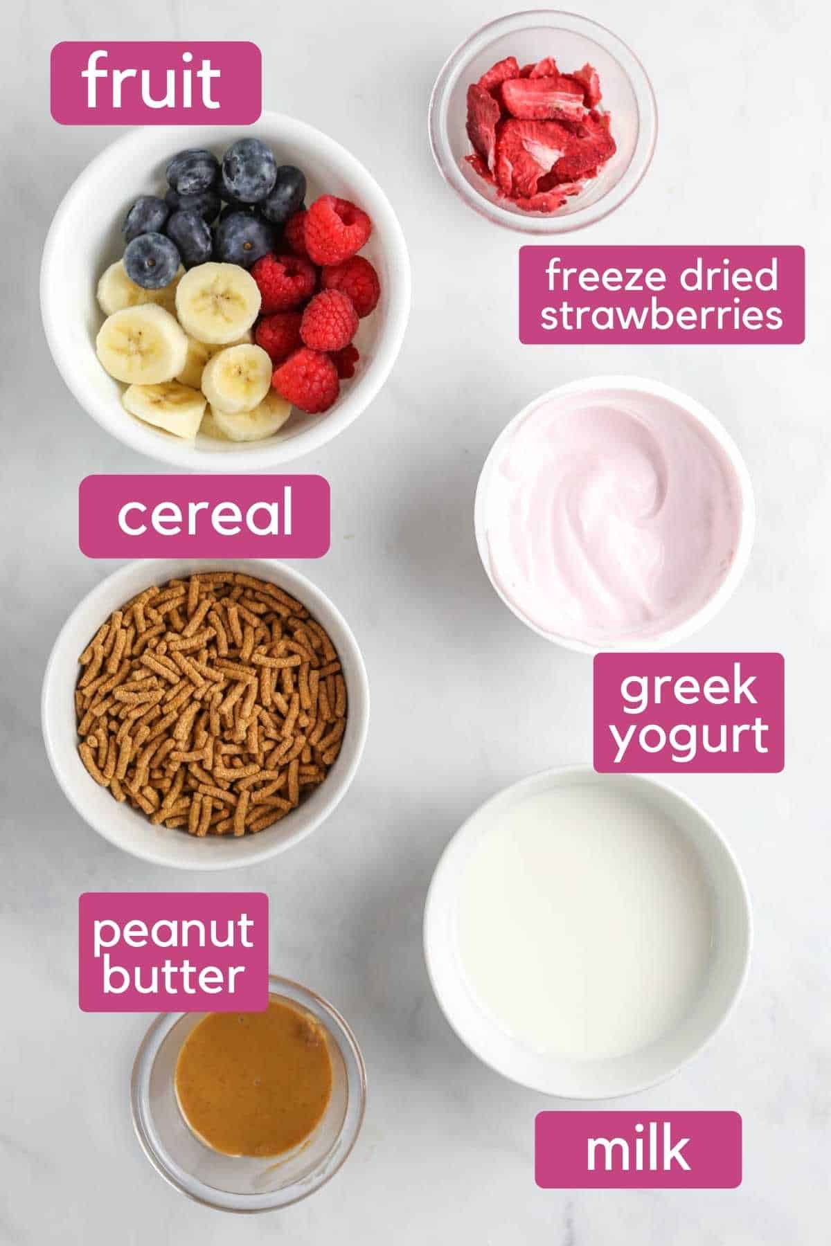 The ingredients needed to make a smoothie cereal bowl, including yogurt, milk, fruit, and cereal.