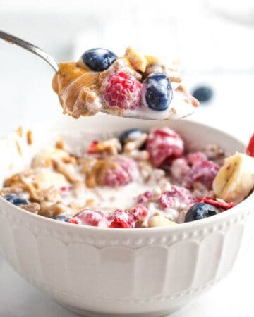 A spoonful of smoothie cereal with berries.