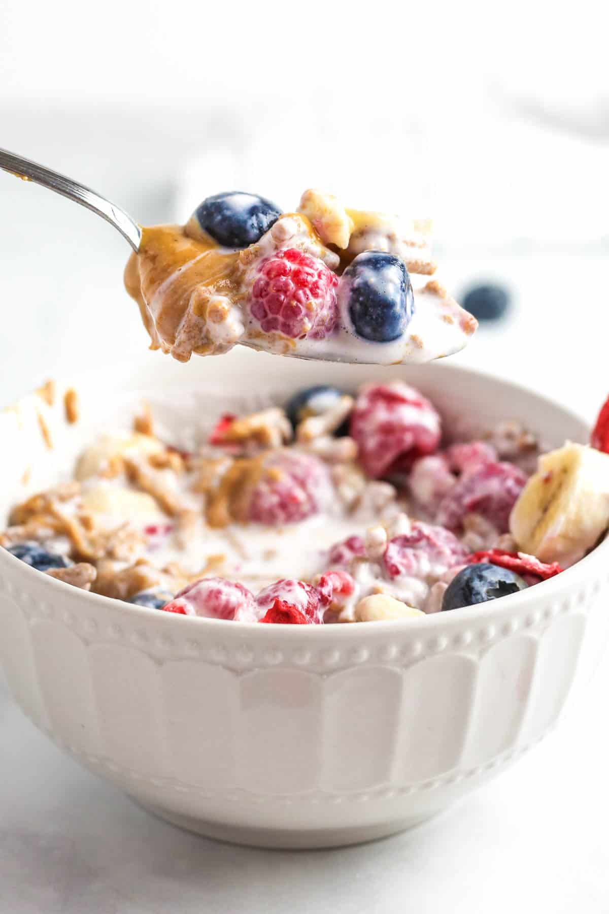 A spoonful of smoothie cereal with berries.