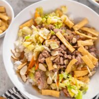 A bowl of stir fried cabbage, vegetables, and ground turkey.