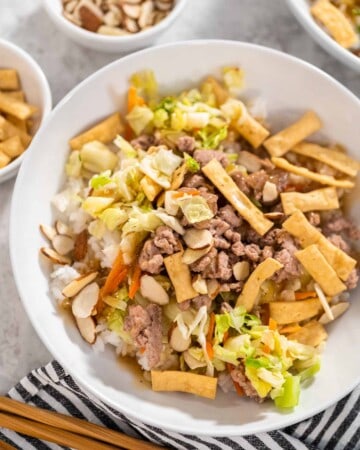 A bowl of stir fried cabbage, vegetables, and ground turkey.