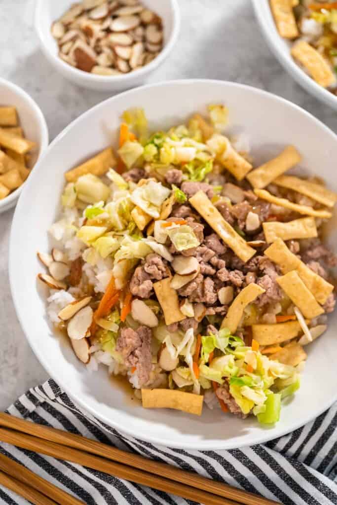 A bowl of stir fried cabbage, vegetables, and ground turkey.