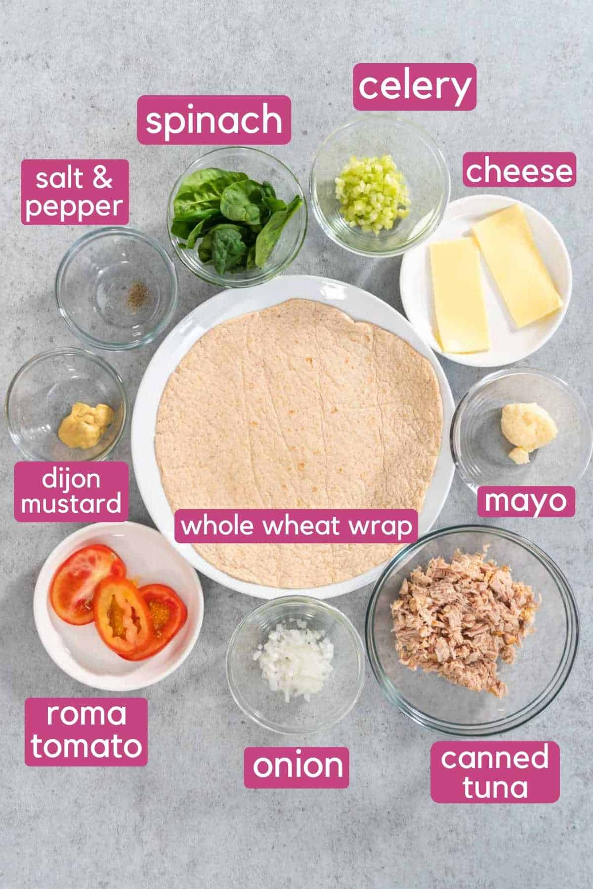 The ingredients needed to make a tuna melt wrap, including canned tuna, tomatoes, and whole wheat wrap.