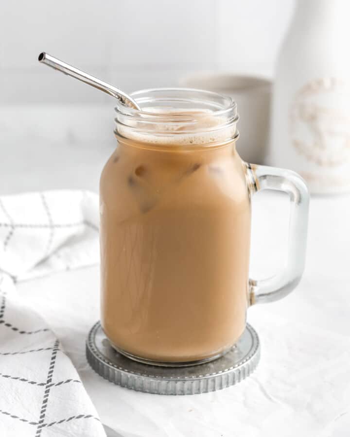A large glass mug filled with iced protein coffee.