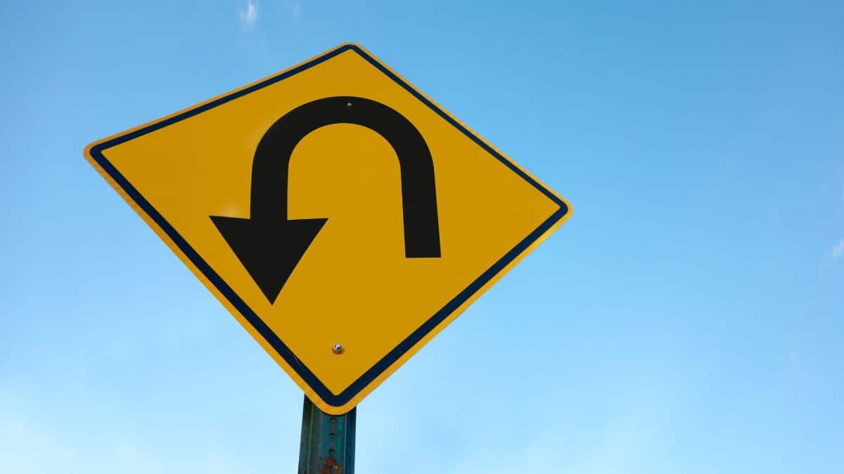 u-turn sign with sky background.