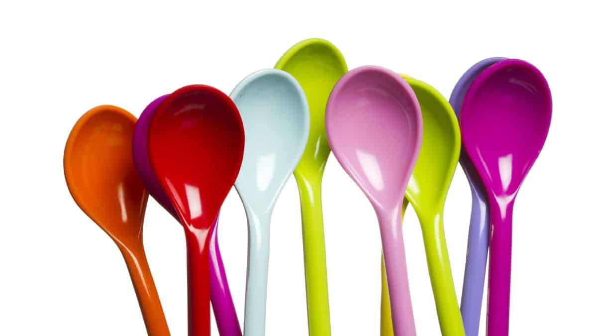 multi-colored spoons on white background.