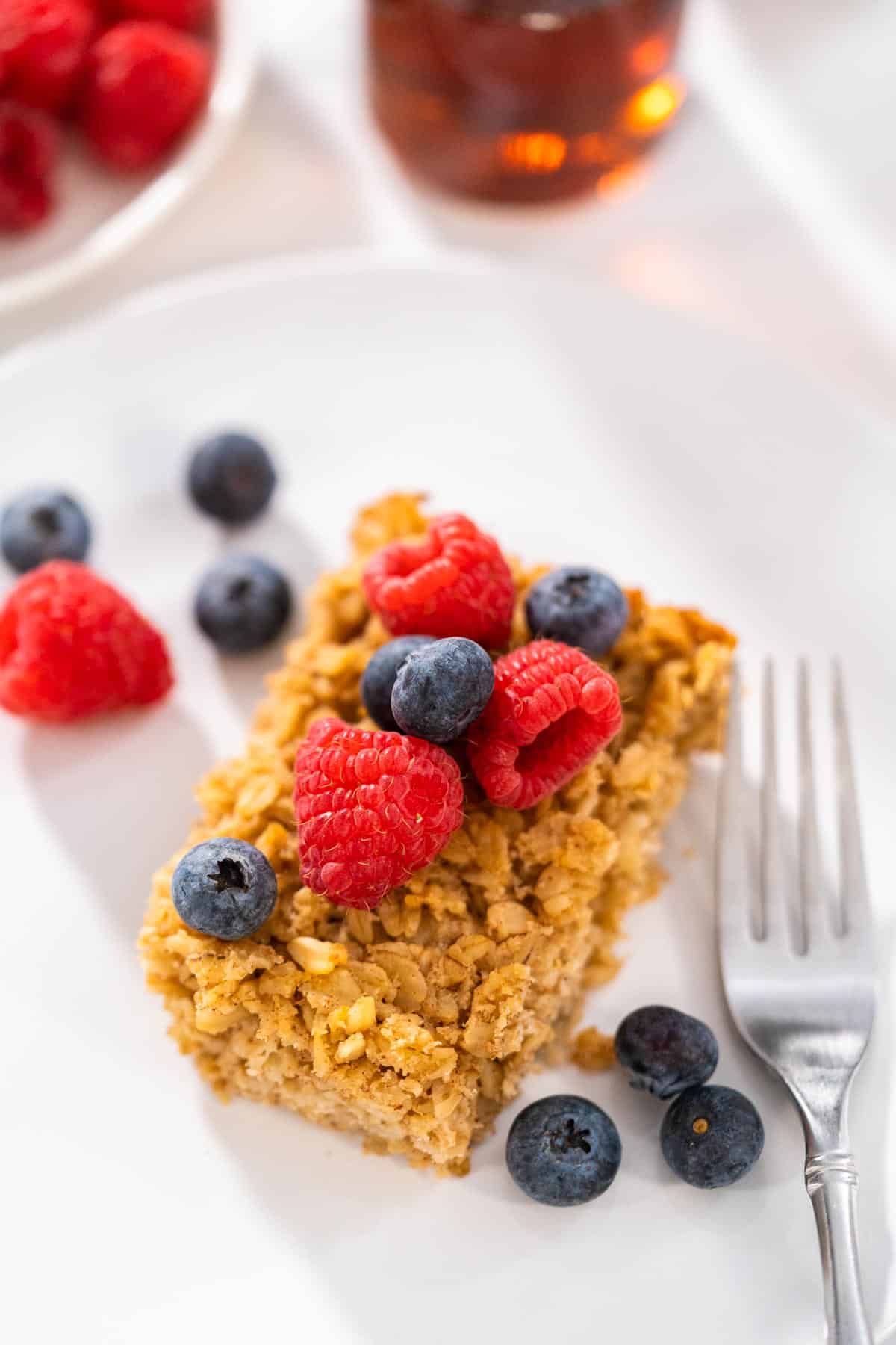 A square of oatmeal, topped with fruit.