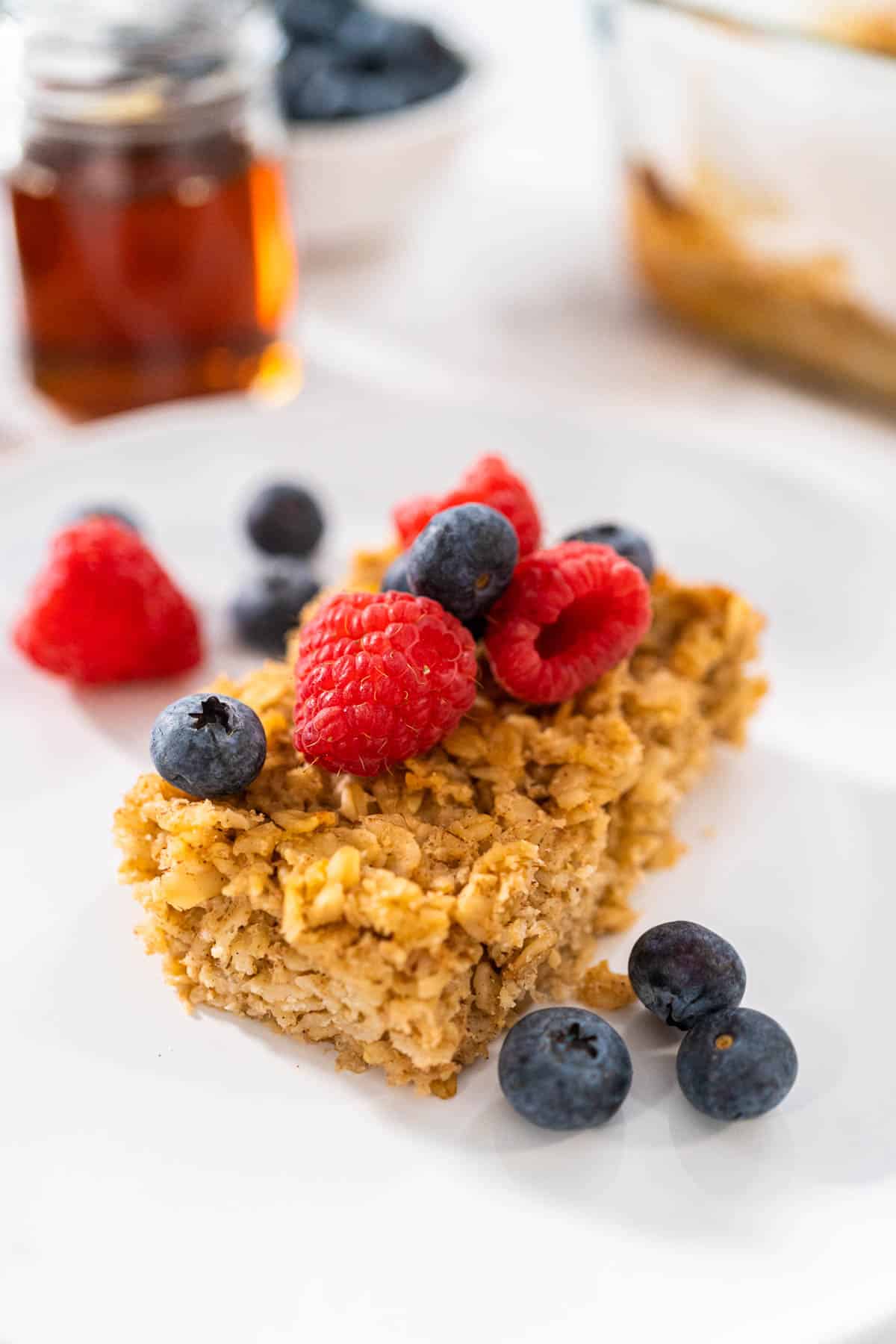 A square of baked oatmeal topped with berries.