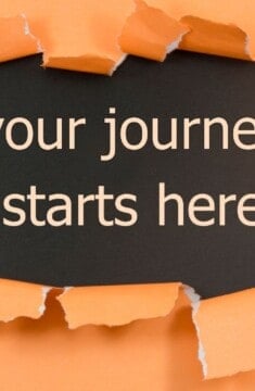 your journey starts here typed on black paper with orange paper ripped around it.