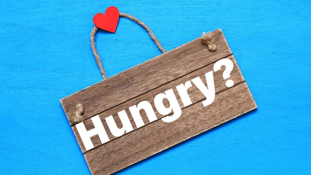 wood sign that reads Hungry_ with heart on the handle.