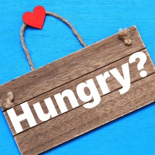 wood sign that reads Hungry_ with heart on the handle.