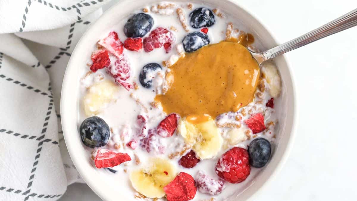 smoothie cereal with spoon and dollop of peanut butter on top.